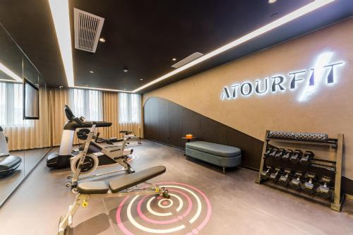 a gym with cardio equipment and a workout room at Atour Hotel Jiaxing Haiyan Haifeng Road in Haiyan