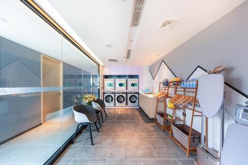a laundry room with a glass wall at Atour Hotel Jining Lingxiu City Plaza in Jining