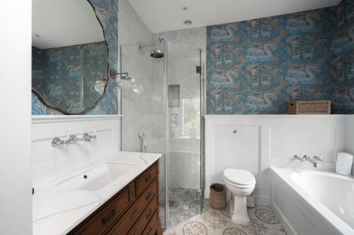 a bathroom with a sink and a toilet and a shower at Shrewton House - Stunning 4 double ensuite bedrooms in Shrewton