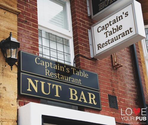 a sign for a nut bar on the side of a building at Keppels Head Hotel in Portsmouth