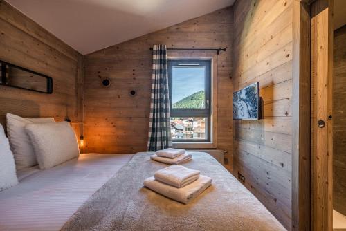 Voodi või voodid majutusasutuse Apartment Merbau Les Gets - by EMERALD STAY toas