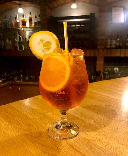 a drink with an orange slice on a wooden table at Sosnowe Zacisze in Białystok