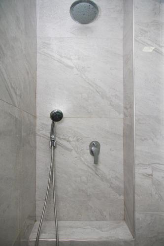 a shower with a shower head in a bathroom at Apartments4you Leonardo 11 in Bat Yam