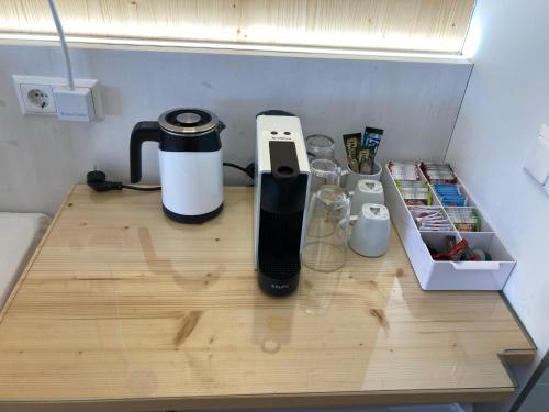 a counter with a coffee maker on a table at Seehotel am Hallstättersee modern rooms in Obertraun