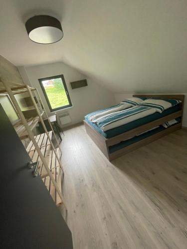 a bedroom with a bed and two bunk beds at Chata Lahvanka in Vítkovice