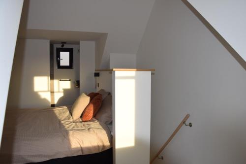 a bedroom with a bed with two pillows at CaCeLe Raveelzicht in Zulte