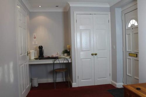 a kitchen with a counter and a white door at The Sportsman Chalets in Kent