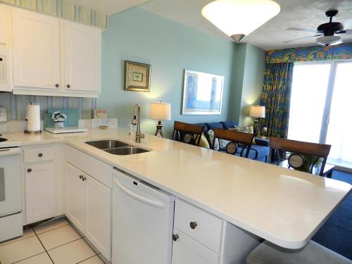 a kitchen with a sink and a counter top at 13th Floor 1 BR Resort Condo Direct Oceanfront Wyndham Ocean Walk Resort Daytona Beach 1302 in Daytona Beach