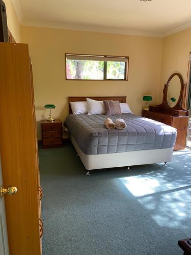 a bedroom with a bed with two teddy bears on it at Abel Tasman Marahau in Marahau