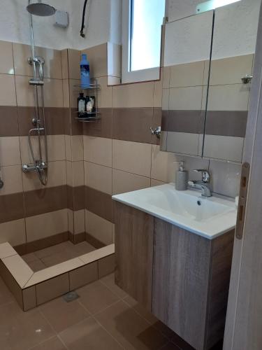 a bathroom with a sink and a shower at Secret Paradise in Koutsounari