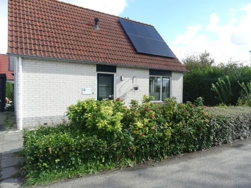 a house with a solar panel on the roof at Kustverhuur, Park Schoneveld, Stern 240 in Breskens