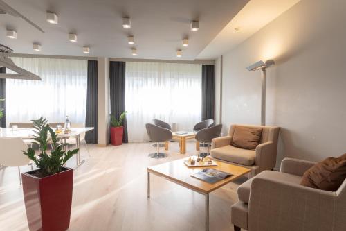 a living room with a couch and chairs and a table at Living Place Hotel in Villanova