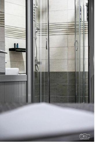 a bathroom with a shower and a sink at Vila Leo Lux in Korçë