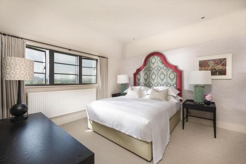 a bedroom with a large bed and a large window at Decoy Farm House in Somerton