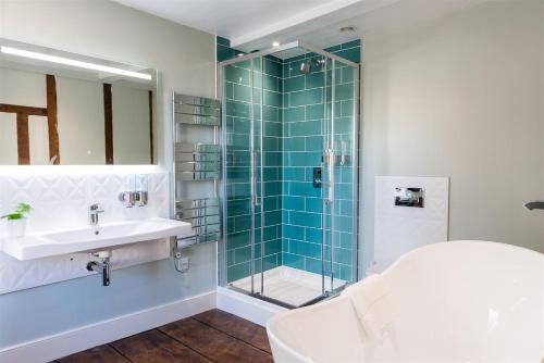a bathroom with a glass shower and a sink at The Boarding House in Halesworth