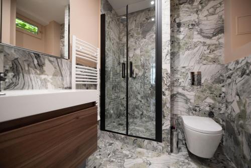 a bathroom with a shower and a toilet and a sink at MBM - CHEMIN VERT in Paris