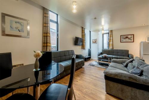 a living room with a couch and a table at Lever St Central in Manchester