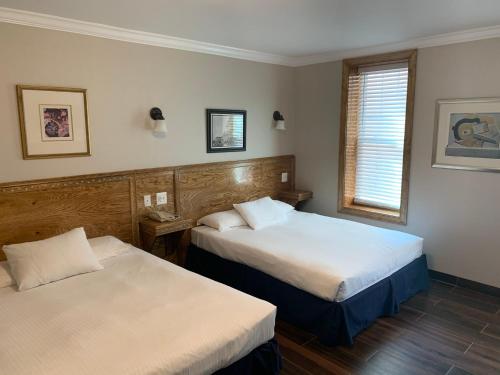 ein Hotelzimmer mit 2 Betten und einem Fenster in der Unterkunft District Hotel in Washington