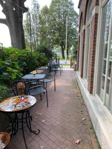 a row of tables and chairs next to a building at City House Bed and Breakfast in Harrisburg