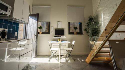 a small kitchen with a small table and chairs at CASA DOURO Porto City in Porto