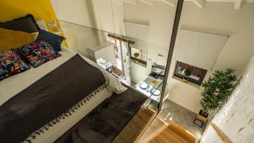 a bedroom with a bed and a glass wall at CASA DOURO Porto City in Porto