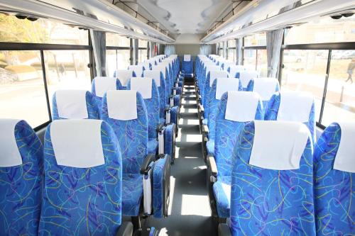 an empty bus with blue and white seats at APA Hotel Keisei Narita Ekimae in Narita