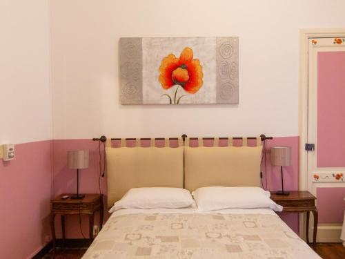 a bedroom with a bed and a painting on the wall at Hotel Portofino in Rapallo