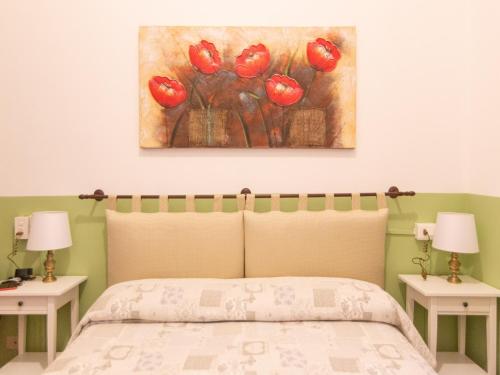 a bedroom with a bed and a painting on the wall at Hotel Portofino in Rapallo