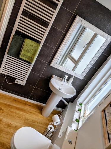 a bathroom with a sink and a mirror at Spacious contemporary apartment in Ramsgate