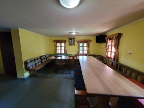 a room with a large wooden table and a couch at Turistična kmetija Kunstek in Rogatec