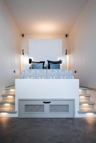 a bedroom with a large bed with a white dresser at Papaya Beach Studios in Tarifa