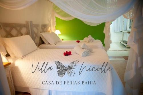 a bedroom with a white bed with a white canopy at Villa Nicolle - Bahia - Praia do Espelho in Praia do Espelho