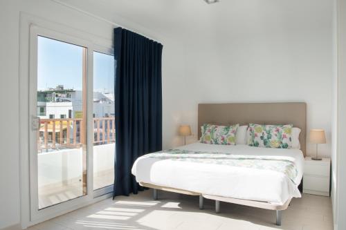a bedroom with a bed and a large window at Blancazul Ocean View in Playa Blanca
