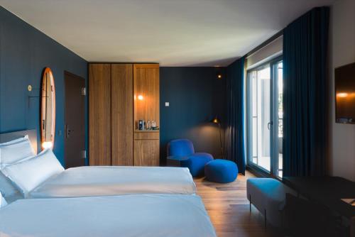 a hotel room with two beds and a window at EmiLu Design Hotel in Stuttgart