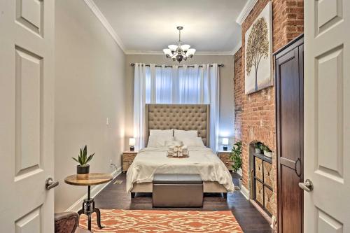 a bedroom with a bed and a brick wall at Chic Baltimore Apartment 2 Mi to Downtown! in Baltimore