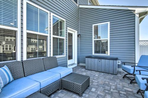 a patio with a couch and a table and chairs at Beach Shuttle and Pool Bishops Landing Townhome in Millville