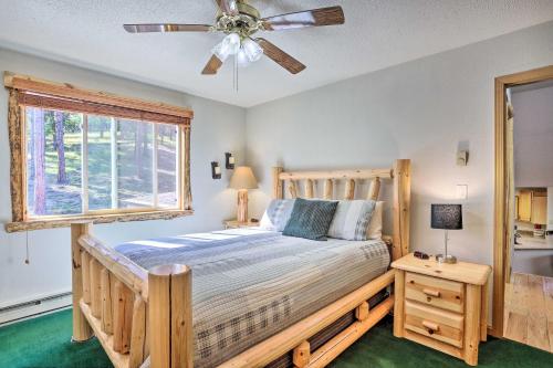 a bedroom with a wooden bed and a window at Spacious Black Hawk Home with Furnished Deck! in Blackhawk