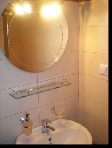 a bathroom with a sink and a mirror at Hotel Sarandos in Ammouliani