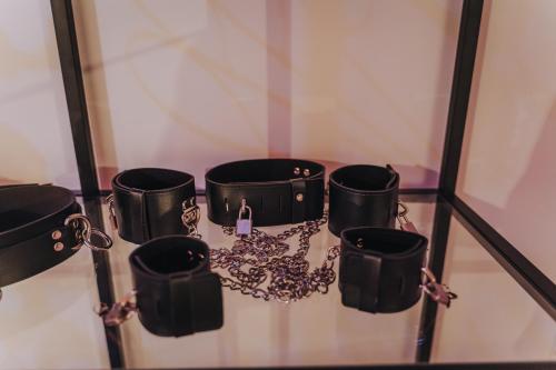 a group of black coffee mugs on a glass shelf at La Villa Monroe - Un écrin de volupté épicée in Le Vézier