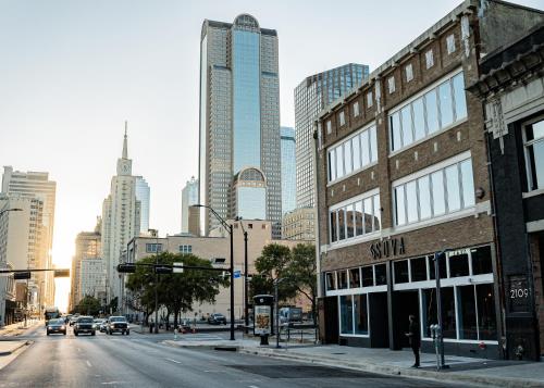an empty street in a city with tall buildings at SOVA Micro-Room & Social Hotel in Dallas