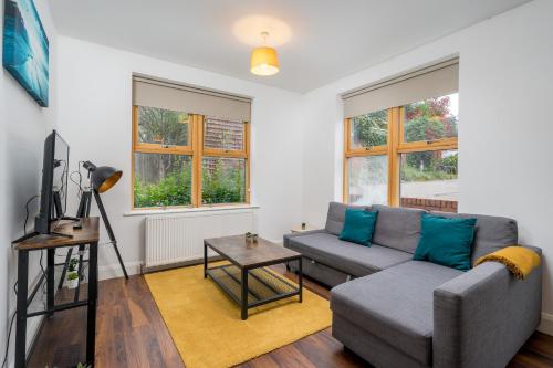 a living room with a couch and a table at Stylish Central Watford 2 Bedroom and Sofa Bed Apartment with Free Parking in Watford