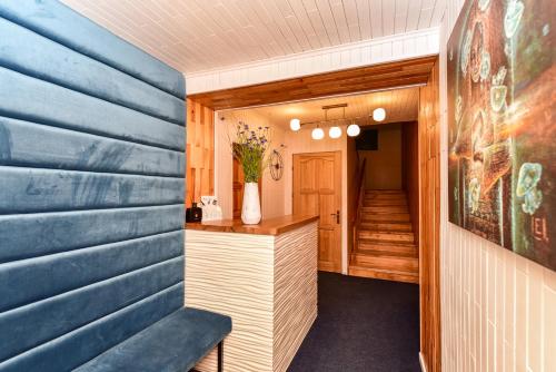 a home office with a blue wall at Svečių namai Banga in Paplatelė