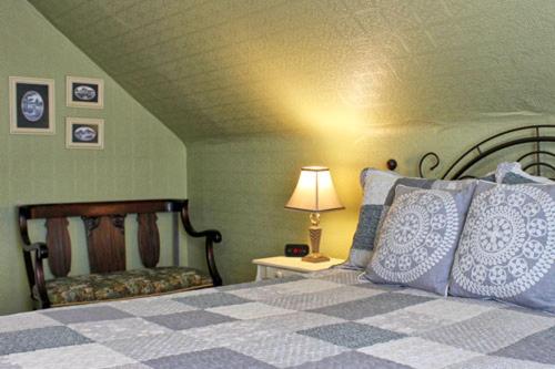 a bedroom with a bed and a lamp on a table at Willow House Inn B&B in Pictou