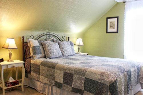 a bedroom with a large bed and two lamps at Willow House Inn B&B in Pictou