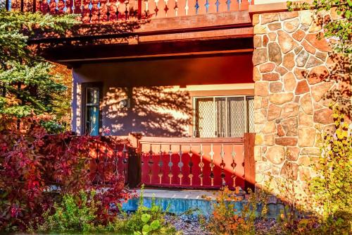 a red bench in front of a house at Eagle Springs East 101: Red-wing Suite in Solitude