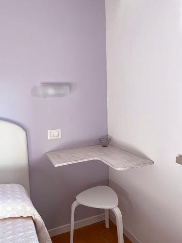 a shelf in a room with a chair and a bed at Dimora Toscana in Treggiaia