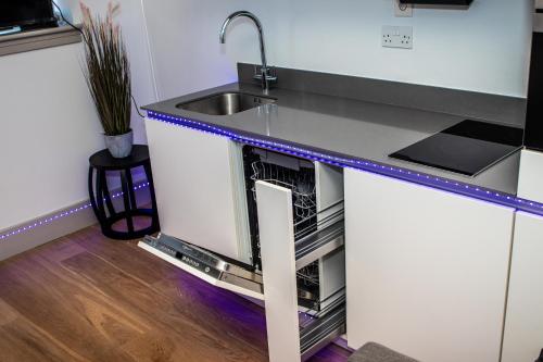 a kitchen with a sink and a dishwasher at Stunning 1-Bedroom flat in London! in London