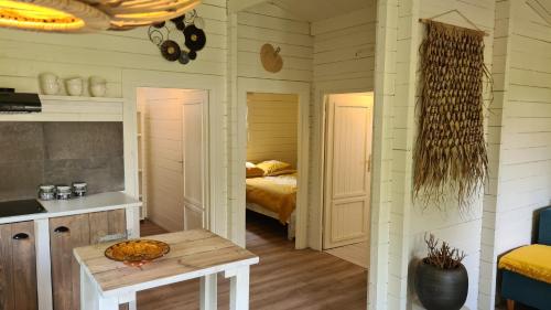 a bedroom with a bed and a table in a room at Casa Ibiza is vakantie in Drenthe in Schoonebeek