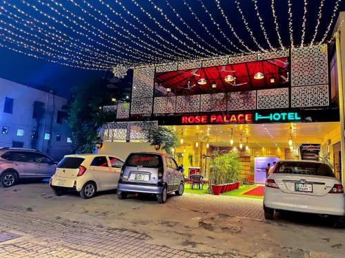 a group of cars parked in front of a store at Rose Palace Hotel, Gulberg in Lahore