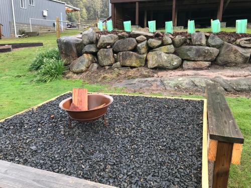 a pot sitting on a pile of gravel next to a stone wall at Derby Digs Barn in Derby